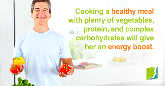 Cooking a healthy meal with plenty of vegetables, lean protein, and complex carbohydrates will give her an energy boost. 